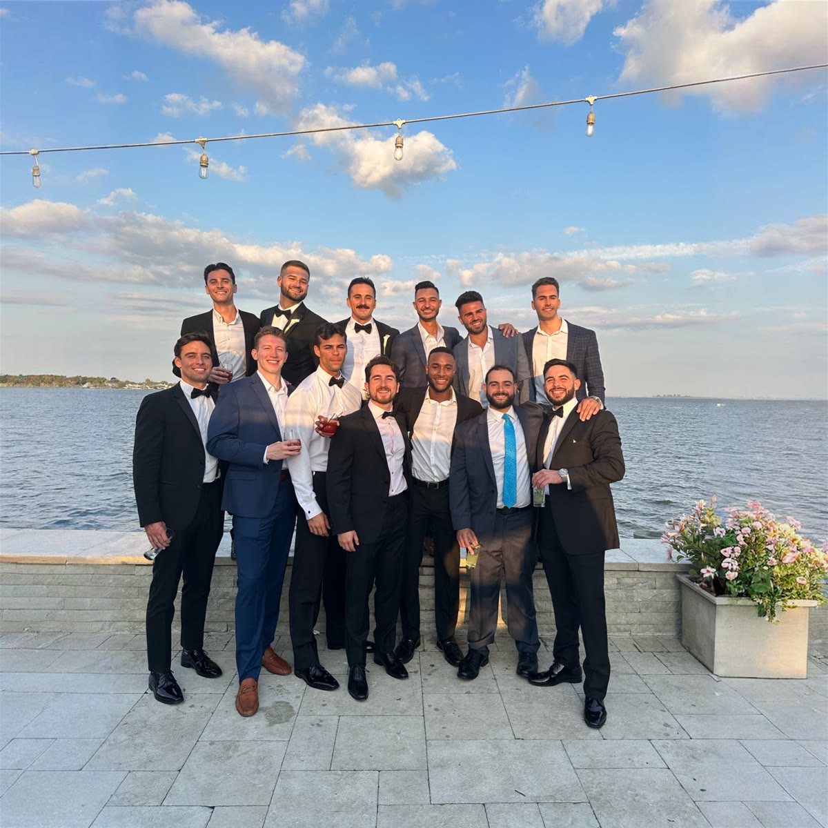 Joe and friends celebrating together by the water