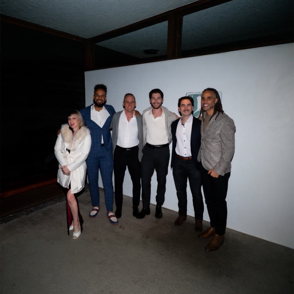 Joe with a group at an evening gathering