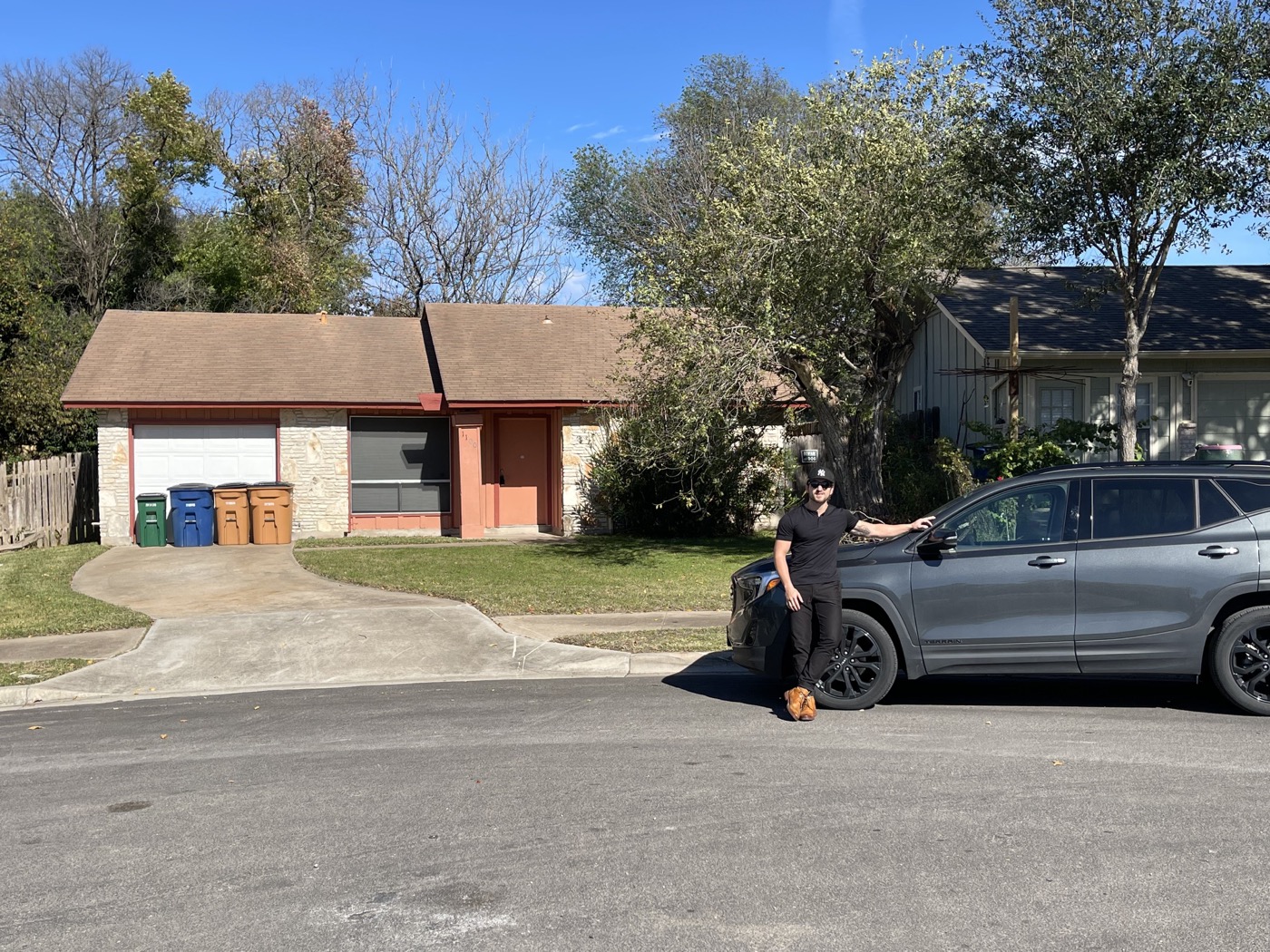 Joe beside a vehicle outside a residential property