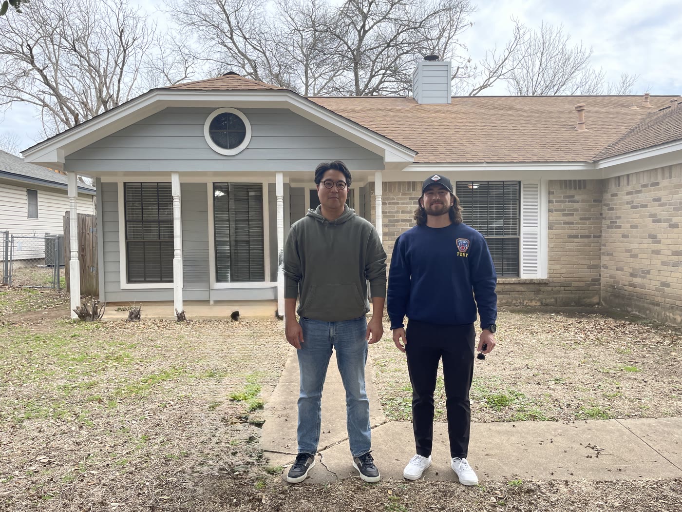 Joe and a collaborator outside a residential renovation project