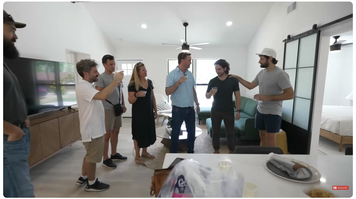 The team celebrating together inside a renovated home